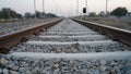 Parallel Railway track on the pebbles closeup. Railroad for fright transportation with electricity pillar