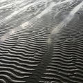 Parallel ridges of textured sand form intricate patterns, created by Royalty Free Stock Photo