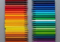 Parallel rows of colored pencils arranged on a gray backgroun Royalty Free Stock Photo