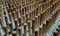 parallel rows of long wooden dowels