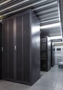 Parallel rows of server racks in datacenter, supercomputer clusters in room