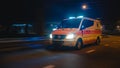 Parallel Shot of a Moving Ambulance Vehicle with Working Strobe Light and Signal Driving to Emerge Royalty Free Stock Photo