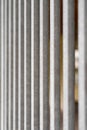 Parallel vertical geometric lines of a galvanized house yard fence lattice