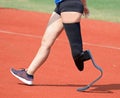 Paralympic athlete with prosthesis in the left leg in the runnin