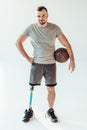 paralympic basketball player with basketball ball sanding akimbo