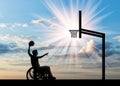 Paralympic disabled person in wheelchair playing basketball in afternoon