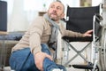 paralyses man on floor by wheelchair Royalty Free Stock Photo