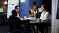 Paralyzed businessman in wheelchair is ignored while working in business office meeting room Royalty Free Stock Photo