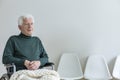 Paralyzed man in a wheelchair in a waiting room in a hospital