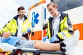 Paramedic and emergency doctor caring for injured boy