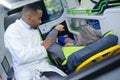 Paramedic holding arm man in ambulance
