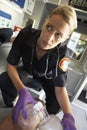 Paramedic holding oxygen mask over patient's face