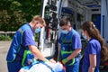 Paramedic man fixes the patient for transportation on vacuum mattress Royalty Free Stock Photo