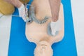 Paramedic practicing resuscitation on dummy