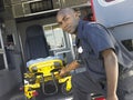 Paramedic removing gurney from ambulance Royalty Free Stock Photo