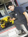 Paramedic removing gurney from ambulance Royalty Free Stock Photo