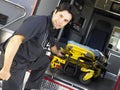 Paramedic removing gurney from ambulance Royalty Free Stock Photo