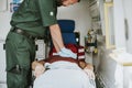 Paramedic resuscitating a patient in an ambulance