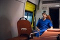 Paramedic sitting in an ambulance car, having a rest, meditating, it is raining outside Royalty Free Stock Photo