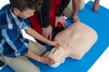 Paramedic training cardiopulmonary resuscitation to boy Royalty Free Stock Photo