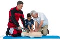 Paramedic training cardiopulmonary resuscitation to senior man and boy Royalty Free Stock Photo
