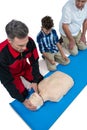 Paramedic training cardiopulmonary resuscitation to senior man and boy Royalty Free Stock Photo