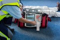 Paramedic using an external defibrillator during cardiopulmonary resuscitation