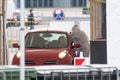 Paramedic wearing protective equipment testing patient in a mobile testing station tent for cars