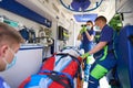 Paramedic woman puts a dropper with painkillers on the patient