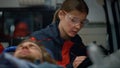 Paramedic writing diagnosis of victim on clipboard. Doctor examining patient Royalty Free Stock Photo