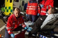 Paramedics assisting injured motorcycle man driver