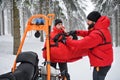 Paramedics from mountain rescue service provide operation outdoors in winter in forest.