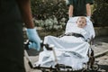 Paramedics moving a young patient on a stretcher to an ambulance