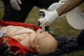 Paramedics perform CPR to a plastic dummy during a public demonstration on how to save a victim Royalty Free Stock Photo