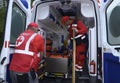 Paramedics putting the sufferer on the stretcher in the emergency car