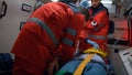 Paramedics rescuing patient in ambulance. Medical team providing first aid help Royalty Free Stock Photo