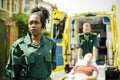 Paramedics rolling a patient on a ambulance stretcher