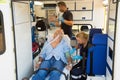 Paramedics treating unconscious man in ambulance