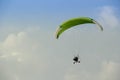 Paramotor flying on the blue sky Royalty Free Stock Photo