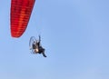 paramotor flying on blue sky background