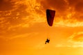 Paramotor flying on the sky at sunset