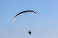 Paramotor pilot flying in a blue sky Royalty Free Stock Photo
