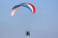 Paramotor pilot flying in a blue sky Royalty Free Stock Photo