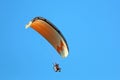 Paramotor pilot flying in a blue sky Royalty Free Stock Photo