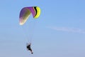 Paramotor pilot flying in a blue sky Royalty Free Stock Photo