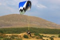 Paramotor pilot flying in to land