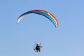 Paramotor pilot flying in a blue sky Royalty Free Stock Photo