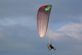 Paramotor pilot flying in a cloudy sky Royalty Free Stock Photo