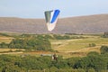 Paramotor pilot landing in the hills of Wales Royalty Free Stock Photo