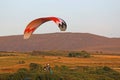 Paramotor pilot landing in the hills of Wales